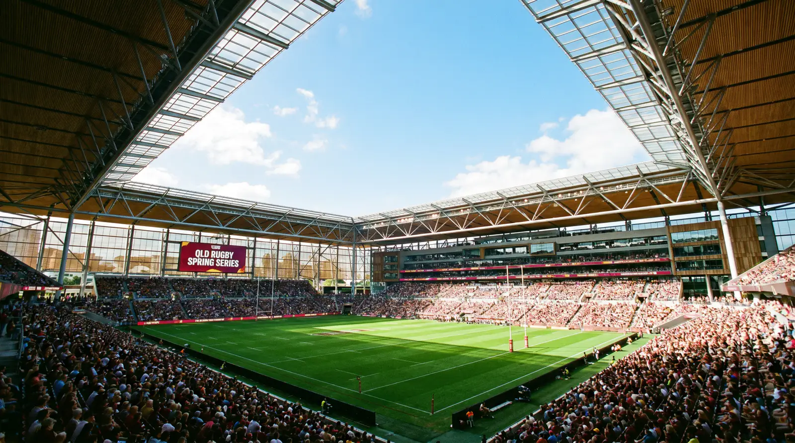 Rugby match played on sunny dry pitch in Australian stadium with open roof