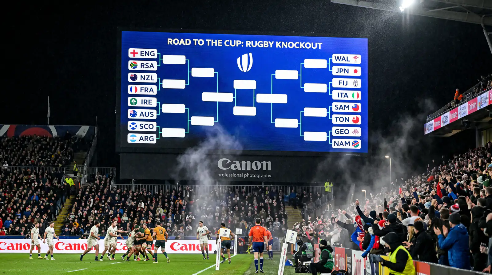 Stadium scoreboard displaying Round of 16 knockout bracket for Rugby World Cup match