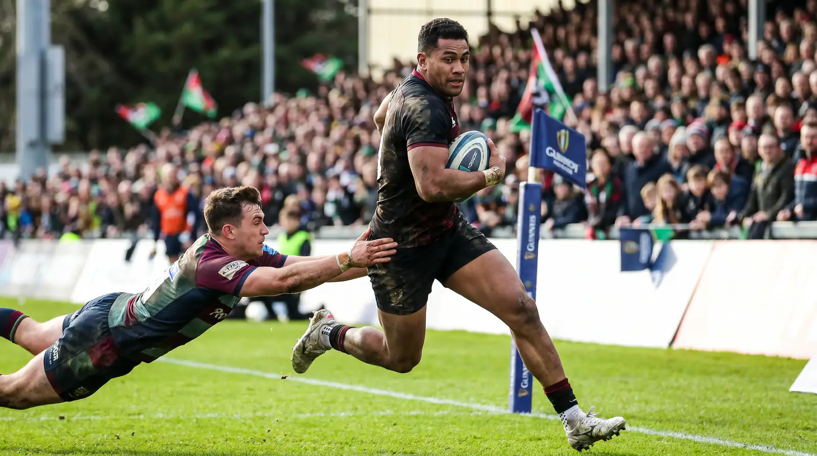 Rugby winger sprinting toward the try line during a world cup match